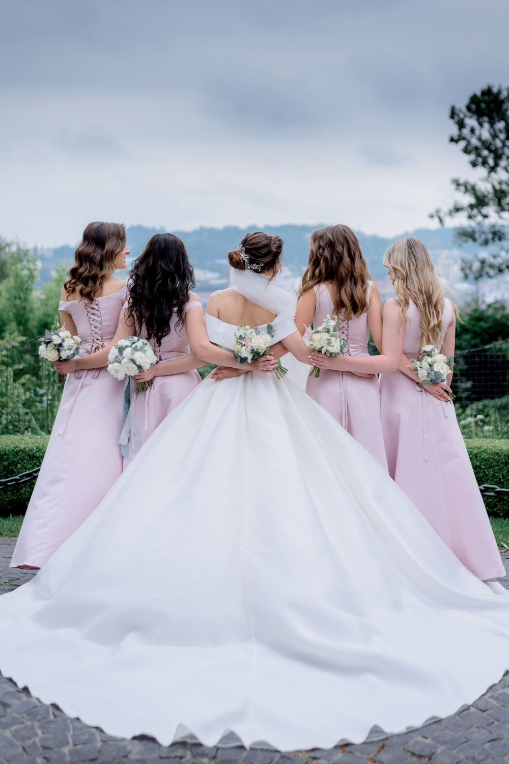 Back view of bride in wedding dress and bridesmaids dressed
